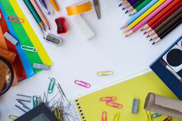Colorful school supplies on white surface with copy space,Able to use vertical or horizontal way. 