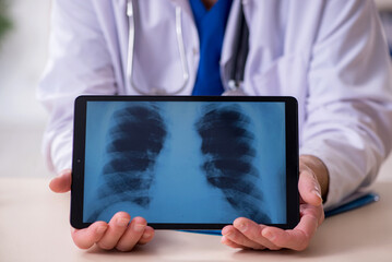 Old male doctor radiologist in telehealth concept