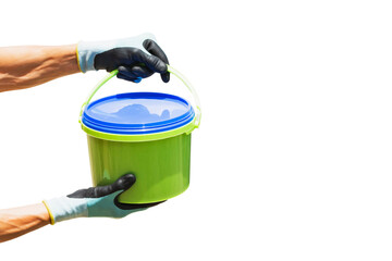 A worker holds a bucket for food