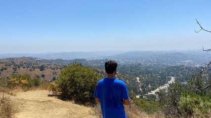Teenager Hiking over looking city
