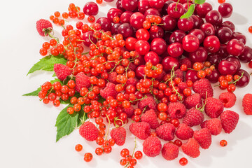 Assorted berry on a white background. Cherries, raspberries, red currants.