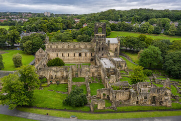 Fototapeta na wymiar The ruins of Kirkstall Abbey in Leeds, Yorkshire England. Old ruined architecture of the abbey and grounds close to Leeds city centre in West Yorkshire. 