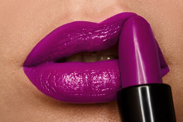 Obraz premium Plump lips with lilac lipstick. Macro photography