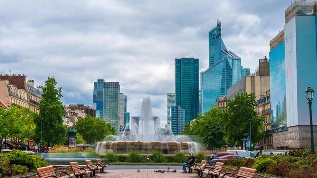 4k timelapse of skyscrapers of Paris business district La Defense on a cloudy summer day. From Pont de Neuilly, west of Paris, France. Camera zooms out