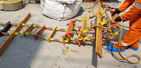 picture of a marine ladder used to usually embark on board boats while they are at sea,also called pilot ladder  © Matvejs