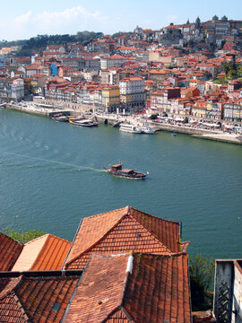 Rebelo boat sailing in Douro river. View over Ribeira in Porto, Portugal.