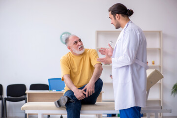 Old patient visiting young male doctor