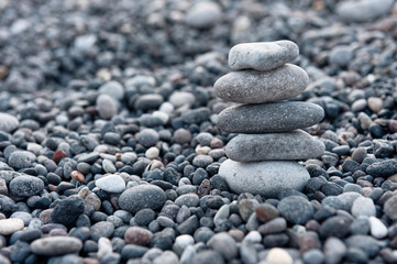 Fototapeta na wymiar Stones pyramid on the beach. Zen and harmony concept.
