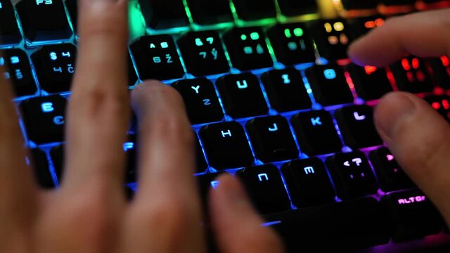 Typing on a gaming keyboard closeup RGB led lighting