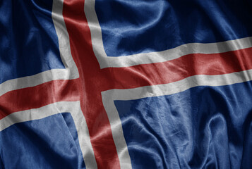 colorful shining big national flag of iceland on a silky texture.