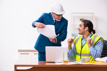 Two male architects working in the office