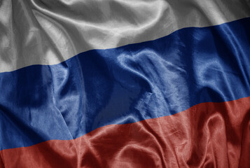 colorful shining big national flag of russia on a silky texture.