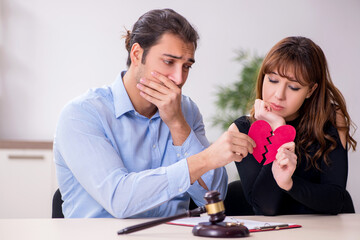 Young pair in courthouse in divorcing concept