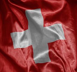 colorful shining big national flag of switzerland on a silky texture.