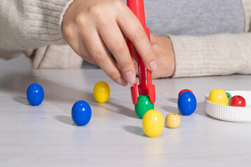 Hand holding tweezers to take objects