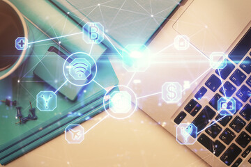 Social network hologram drawings over computer on the desktop background. Top view. Multi exposure. Concept of people connection.