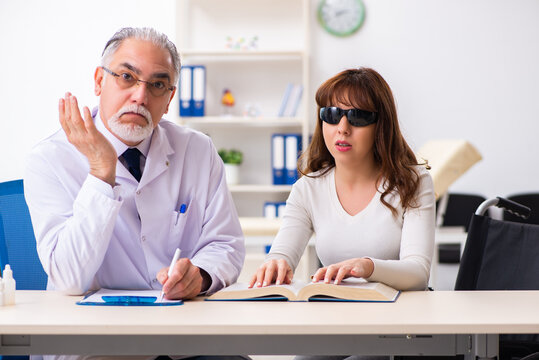 Young woman visiting old male doctor ophthalmologist