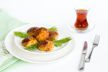Homemade salty pastry on white background with traditional Turkish Tea.