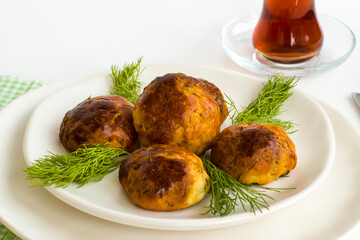 Homemade salty pastry on white background with traditional Turkish Tea.