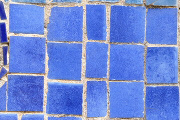 Mosaic wall with blue tiles close up.