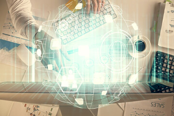 Double exposure of man's hands typing over computer keyboard and social network theme hologram drawing. Top view. People connection web concept.