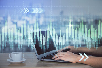 Double exposure of businesswoman hands typing on computer and forex chart hologram drawing. Financial analysis concept.