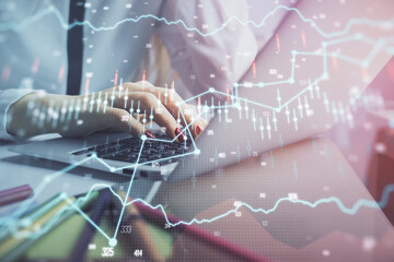 Double exposure of woman hands typing on computer and financial graph hologram drawing. Stock market analysis concept.