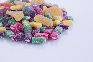 Colorful jelly candies on white surface with copy space,close up taken