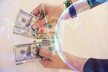 Multi exposure of financial graph drawing hologram and USA dollars bills and man hands. Analysis concept.