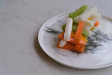close up Chinese pickle（Sichuan pickle）in plate on table. Chinese pickled carrot