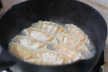 close up cooking fried dumpling in pot. traditional Chinese food. soft focus
