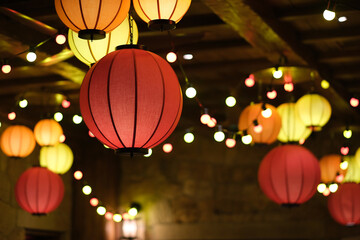 close up colorful traditional Chinese lanterns hanging from ceiling. beautiful and soft focus background