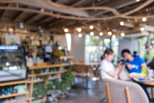 Blur coffee and restutant cafe with customers background.