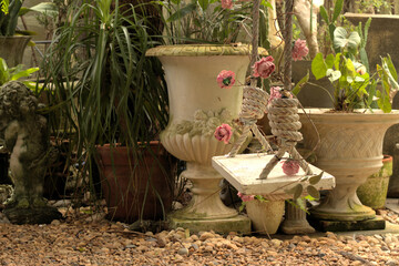 Beautiful garden setting with a swing on a rope and artificial pink flowers attached