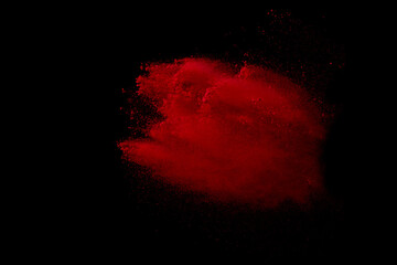 Red powder explosion on black background. 