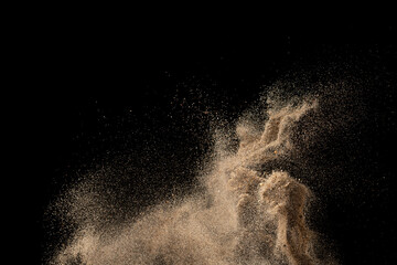 Plakat Gold sand explosion isolated on black background. Abstract sand cloud.