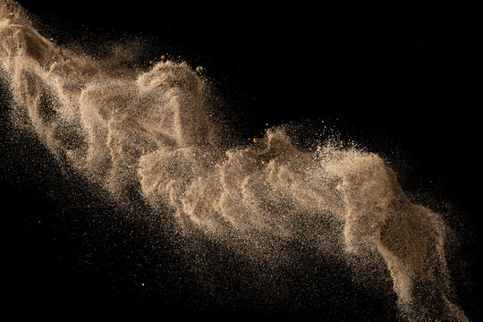 Gold Sand Explosion Isolated On Black Background. Abstract Sand Cloud.