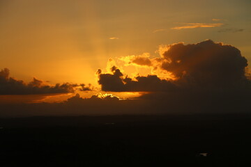 sunset behind clouds