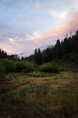 Obraz na płótnie Canvas Cloudy Colorado mountain scenery during sunset. 