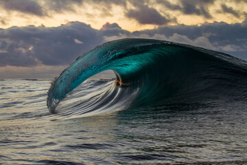wave breaking with sunset reflection