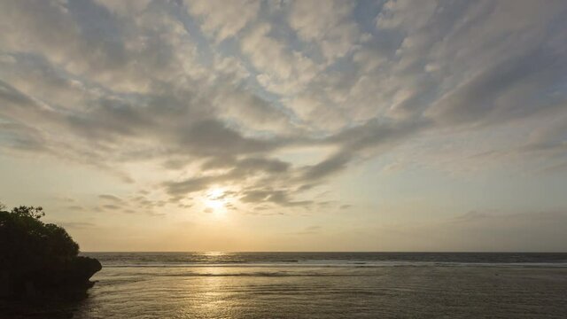 Sunrise in Nusa Dua. Bali. Indonesia. Timelapse hyperlapse. 4k video. Fast clouds moving, low tide beach.