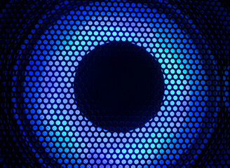 Close-up photograph of a black speaker or sound system with blue led lighting.
