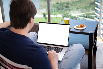 man sitting at computer laptop with isolated screen in cafe