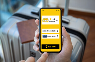 man hand holds phone with application call taxi background luggage