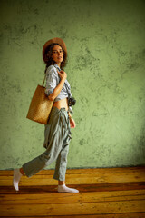 Tourist in a denim jacket and hat with a camera and bag. Happy emotions