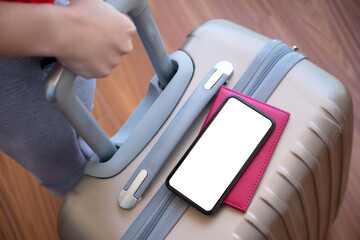 female hands holding suitcase and phone with isolated screen airport