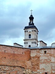 Fototapeta na wymiar catholic cathedral tower behind fortress wall
