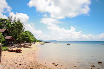 Rocks and boats at sea and blue skies