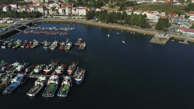 Boats in the marina. Coastal village of Galicia,Spain. Aerial Drone Video