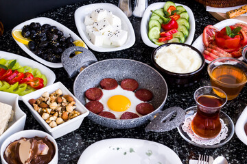 Traditional Turkish Breakfast with sausage egg pan on granite marble table.Close and large view         